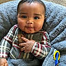 baby, child, face, smile, cookie, hand, blanket, plaid_clothing, cozy, indoor, carpet, happy, cute, portrait, infant, warm, toy, blue, fuzzy, snack