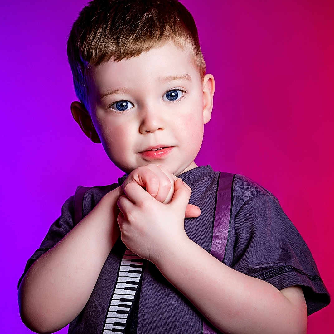 Dean is registered to the contest to win money with this photo: arm, bodypart, boy, child, clothing, face, finger, hand, happy, head, male, mouth, person, photography, portrait, purple, sleeve, smile, t_shirt, wrist
