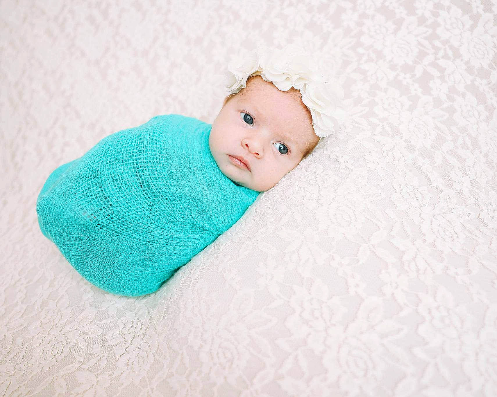 Bella is registered to the contest to win money with this photo: arm, baby, baby_products, baby_toddler_clothing, beanie, child, comfort, craft, electric_blue, eye, face, fashion_accessory, hair_accessory, head, headwear, linens, pattern, person, sitting, sleeve