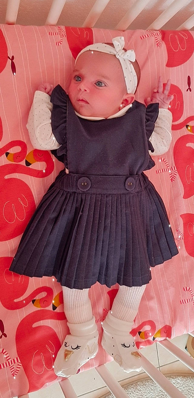 Valentina participe au concours pour gagner de l'argent avec cette photo : baby, baby_toddler_clothing, cheek, child, day_dress, dress, human_leg, knee, magenta, one_piece_garment, outerwear, pattern, peach, person, pink, sleeve, sock, thigh, toddler, waist
