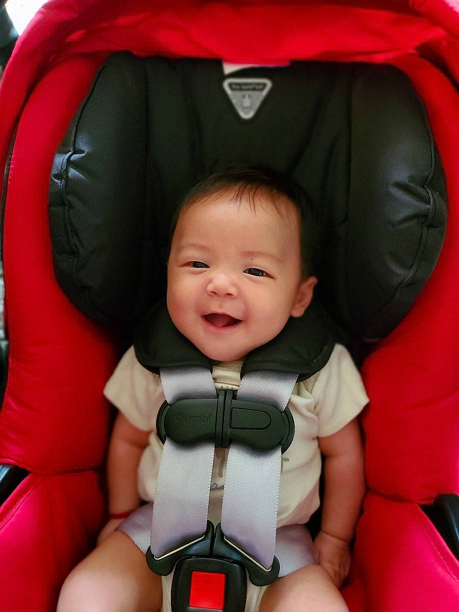 Isaac is registered to the contest to win money with this photo: baby, baby_carriage, baby_carrier, baby_in_car_seat, baby_products, car_seat, car_seat_cover, child, neck, person, product, red, seat_belt, toddler