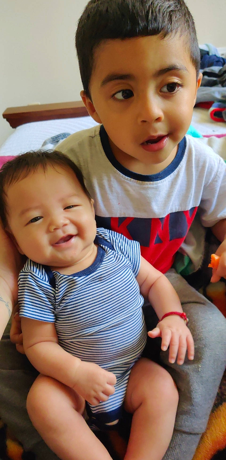 Isaac is registered to the contest to win money with this photo: baby, cheek, child, face, fun, happy, head, nose, people, person, sibling, sitting, skin, smile, t_shirt, toddler, vacation