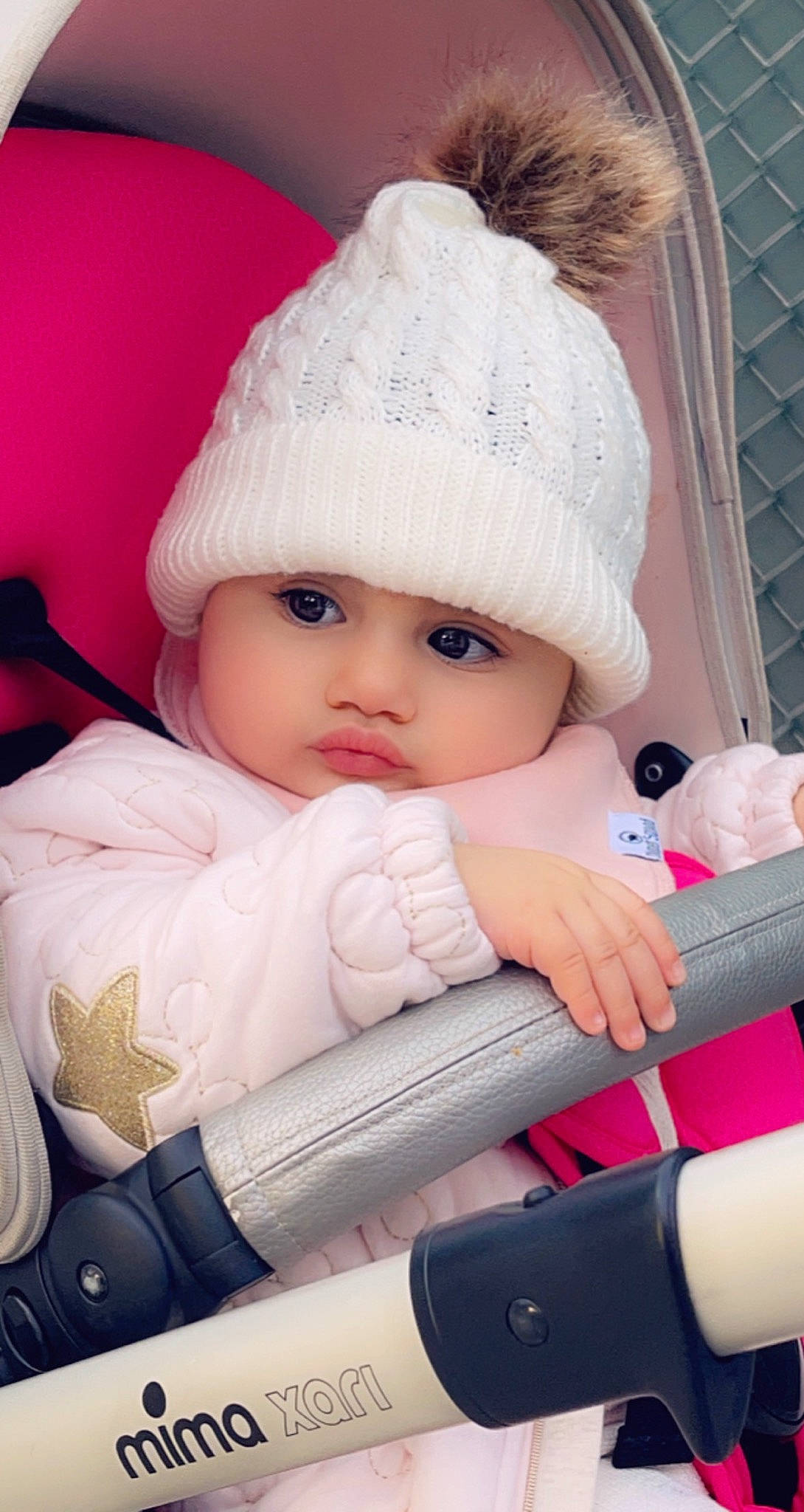 Ella is registered to the contest to win money with this photo: baby, baby_toddler_clothing, cap, car_seat, cheek, child, comfort, fashion_accessory, headgear, headwear, knit_cap, lip, outerwear, people, person, pink, skin, textile, toddler, white