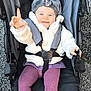baby, child, stroller, jacket, hat, smile, happy, outdoor, footwear, tights, person, clothing, seated, baby_shoes, cold_weather, playful, infant, cute, expression, transport