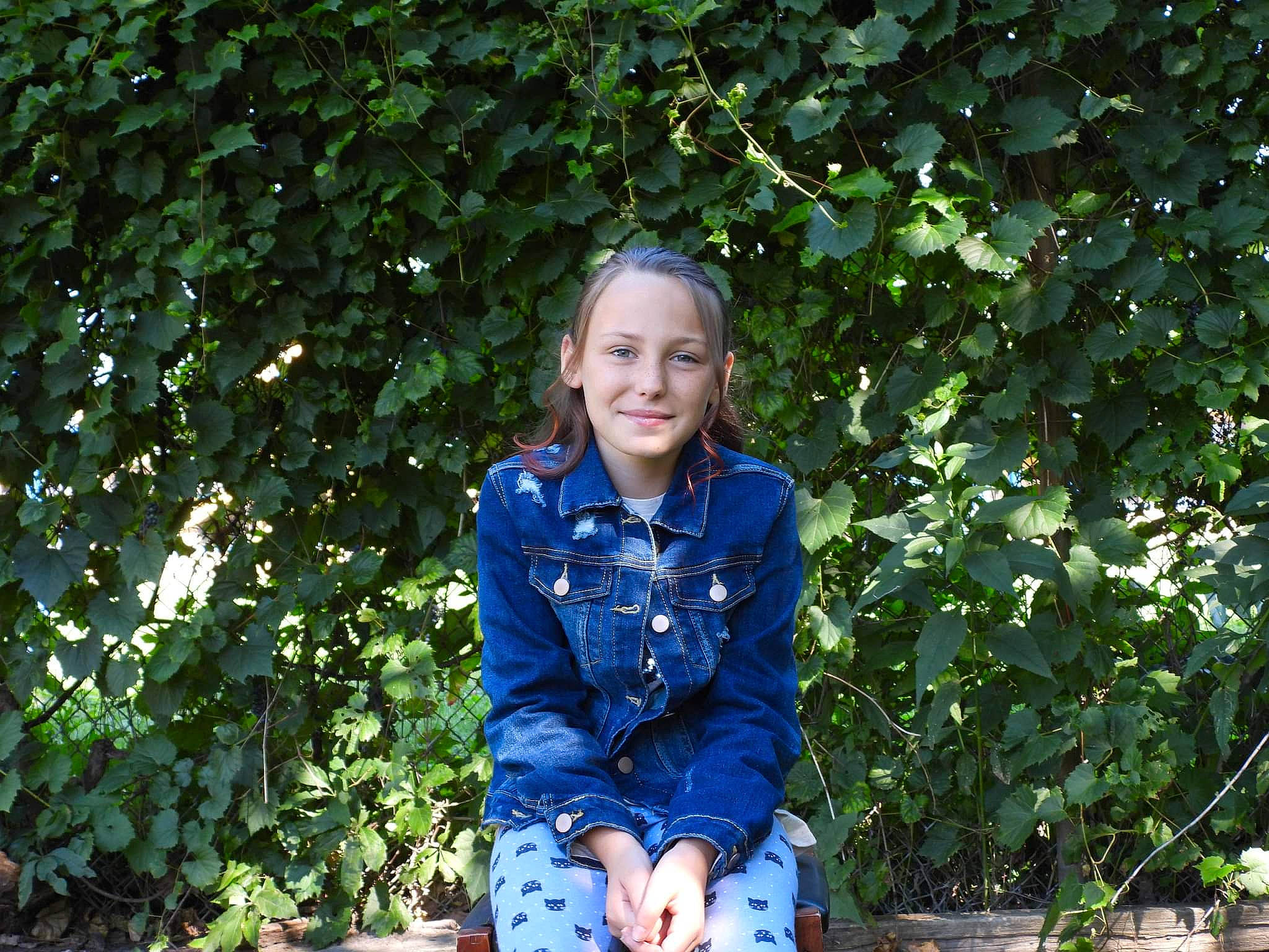 Evelyn joined the competition — help win amazing prizes! child, denim, electric_blue, fun, garden, grass, happy, joy, leaf, leisure, people_in_nature, person, plant, portrait_photography, shrub, sitting, sleeve, smile, soil, t_shirt