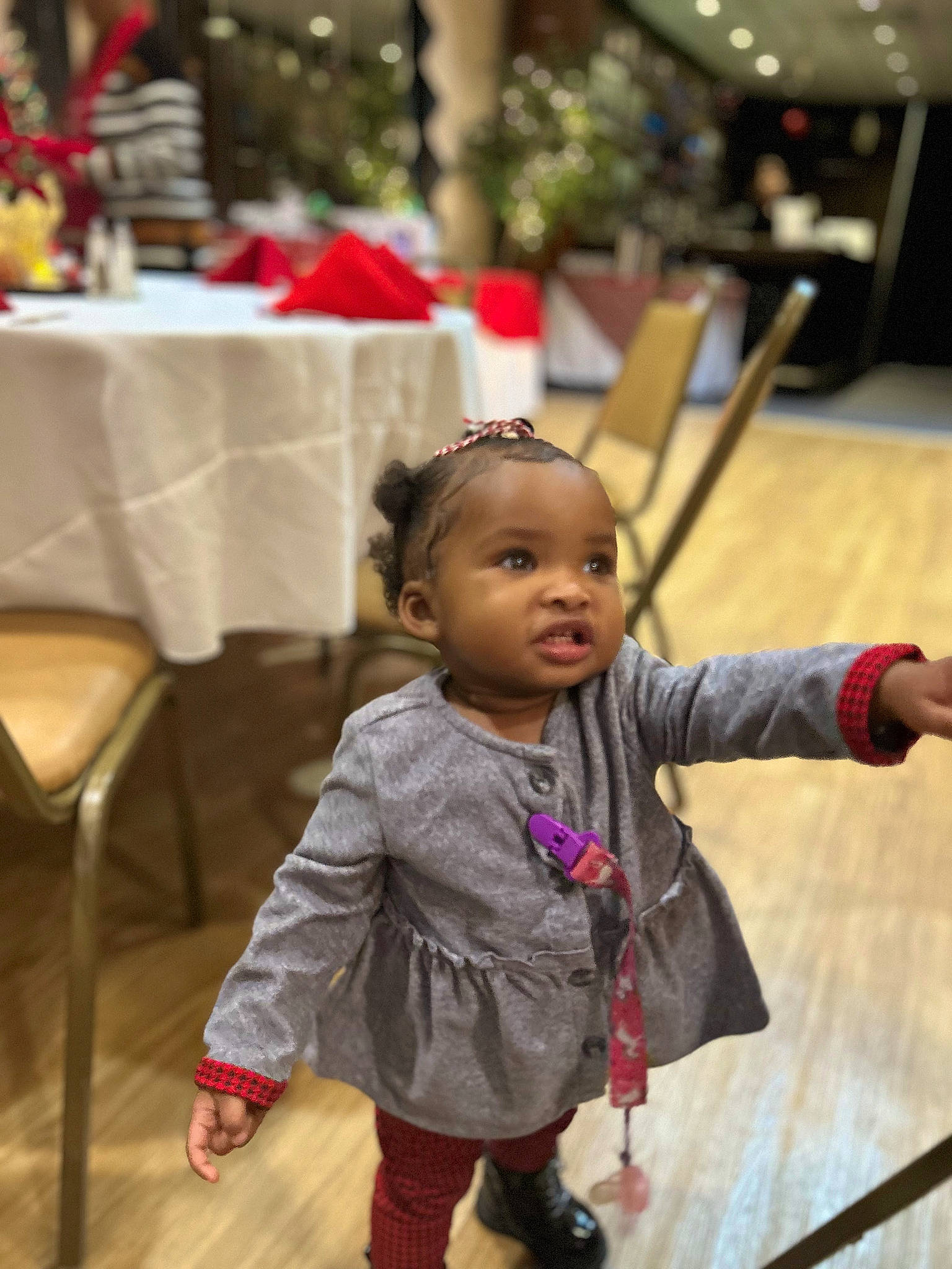 Faith is registered to the contest to win money with this photo: chair, cheek, child, event, floor, flooring, fun, happy, hardwood, leisure, person, room, sitting, skin, table, tablecloth, toddler, tradition, wood, wood_flooring