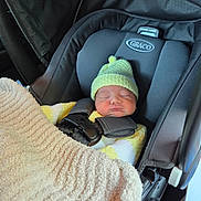 Rodney joined the competition — help win amazing prizes! newborn, baby, car_seat, graco, blanket, hat, sleeping, infant, child, cozy, clothing, safety_harness, seatbelt, transportation, indoors, person, cute, resting, travel, warm