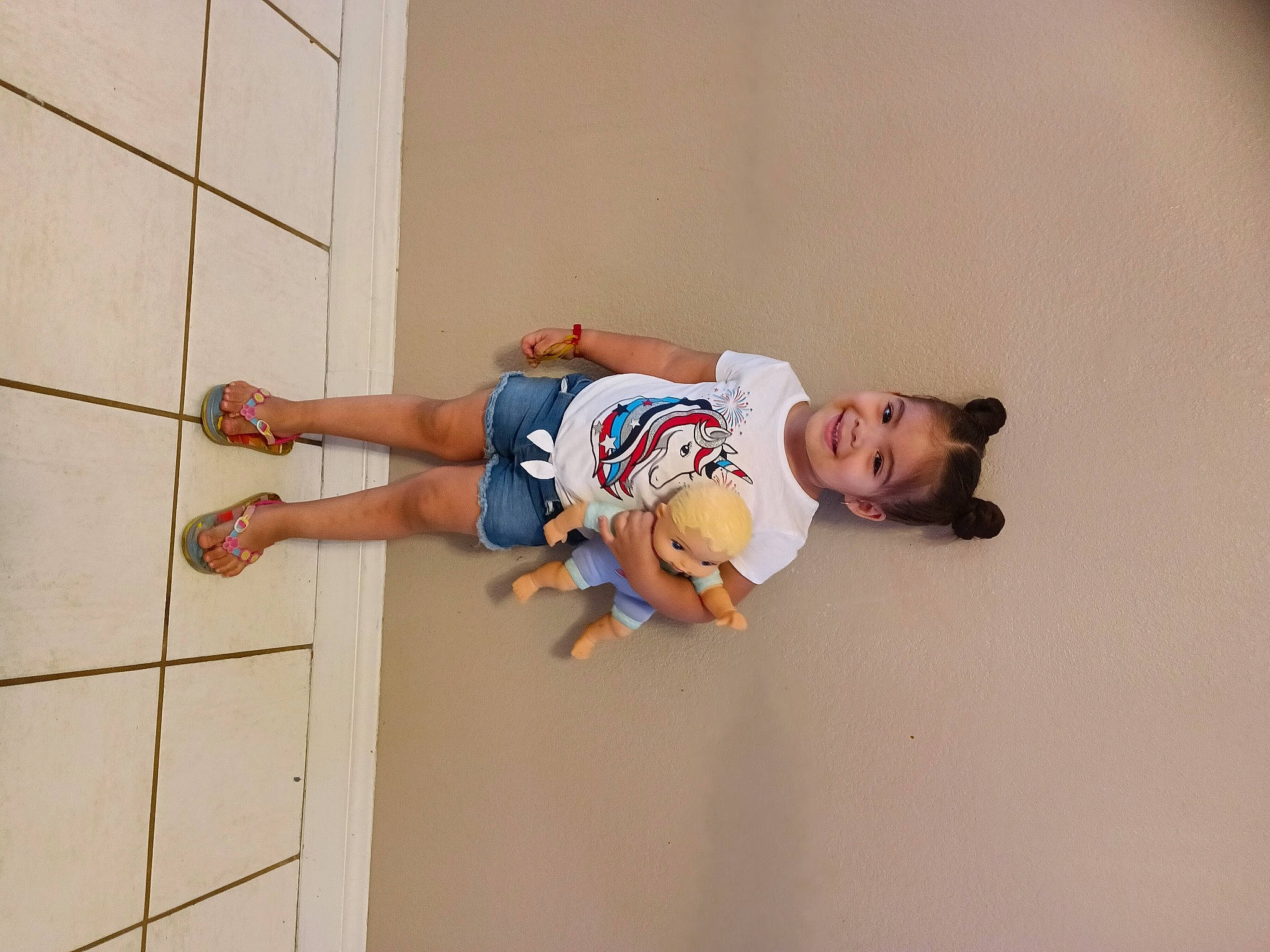 Yvette is registered to the contest to win money with this photo: adventure, child, comfort, elbow, flooring, foot, fun, happy, human_leg, joy, knee, leisure, person, room, shorts, sleeve, t_shirt, thigh, toddler, wood