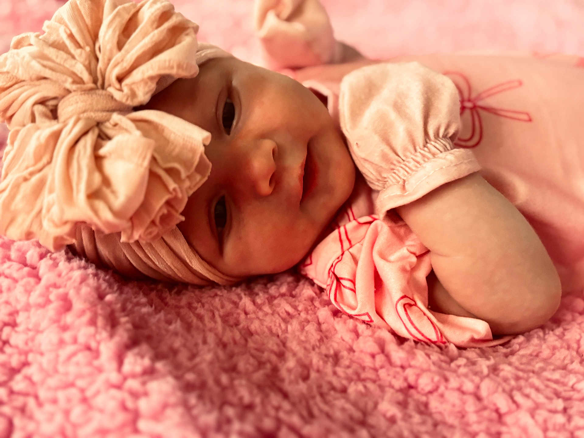 Mia joined the competition — help win amazing prizes! baby, infant, headband, pink, blanket, soft_texture, clothing, portrait, face, cute, sleepwear, newborn, toddler, lying_down, closeup, indoors, child, person, cozy, resting