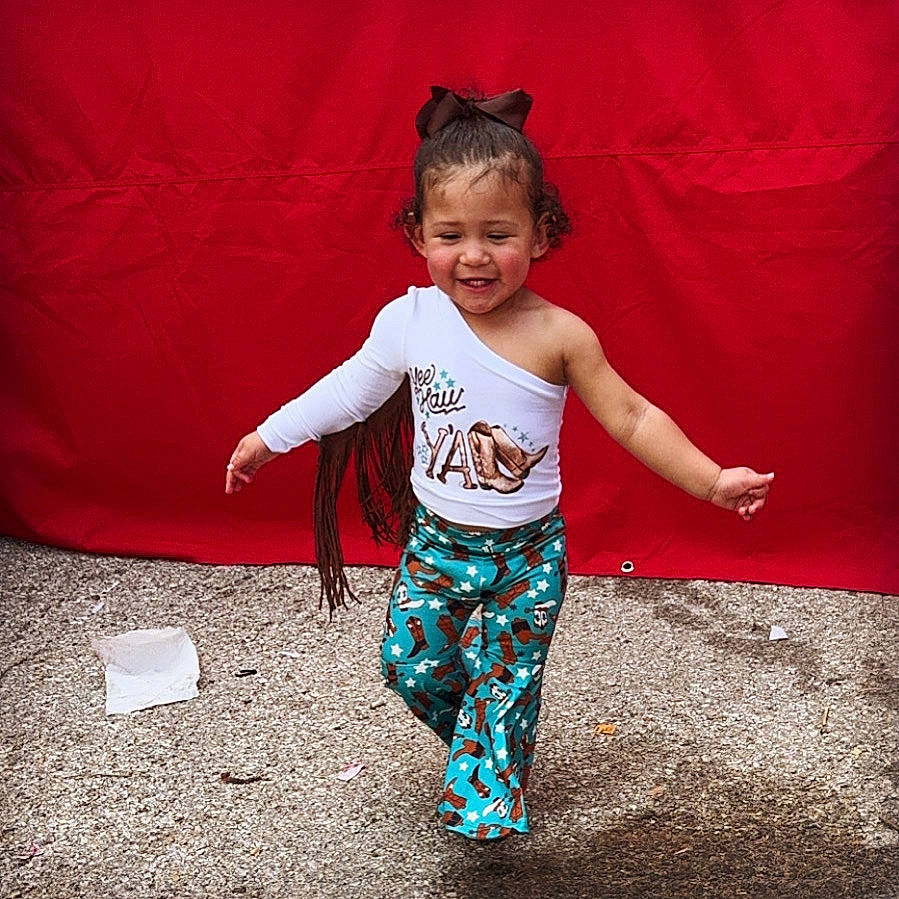 Serenity is registered to the contest to win money with this photo: baby_toddler_clothing, child, electric_blue, eye, flash_photography, fun, gesture, happy, human_body, joy, magenta, pattern, person, sitting, sleeve, smile, sportswear, t_shirt, tints_and_shades, toddler