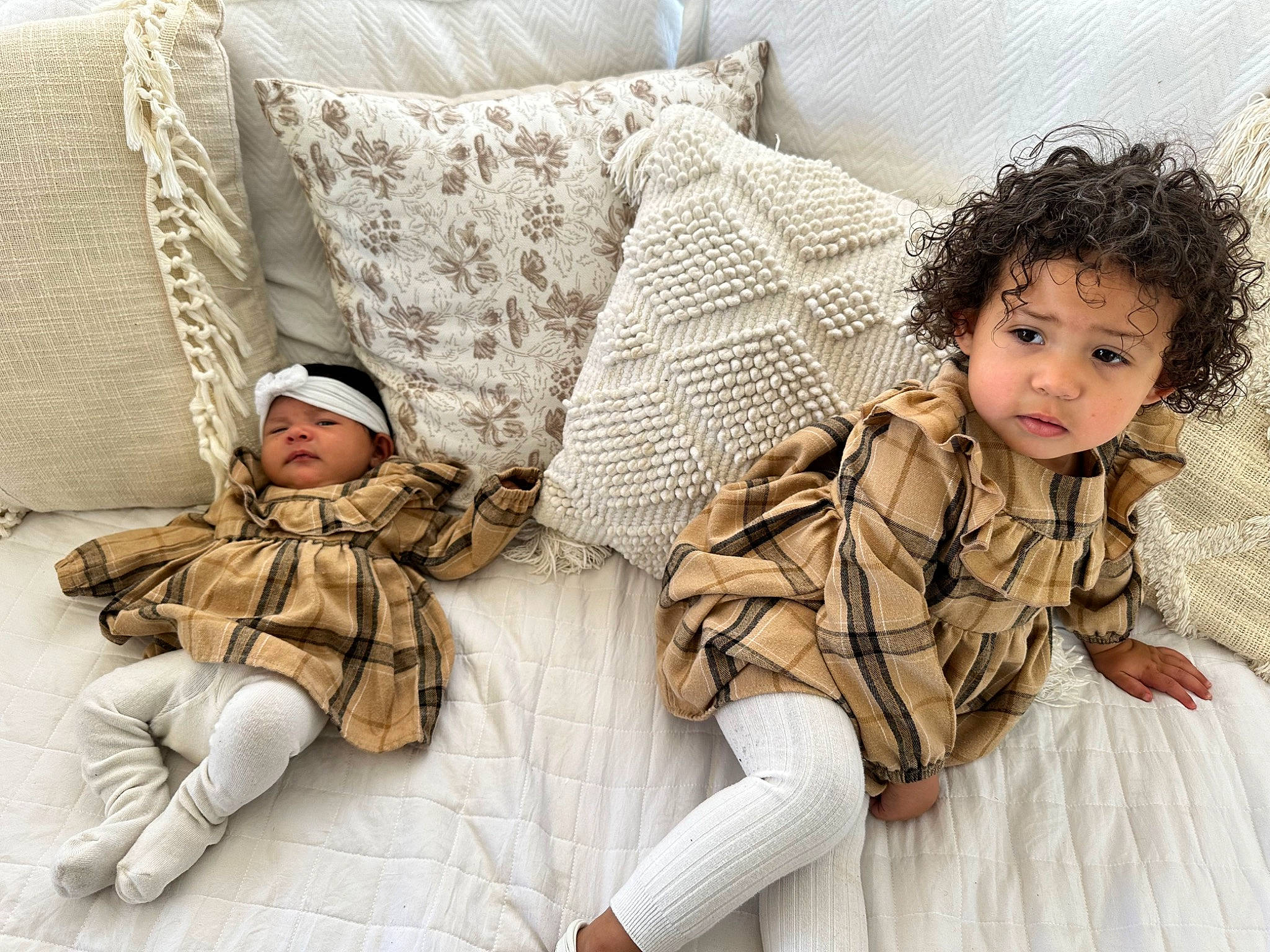 Maliyah joined the competition — help win amazing prizes! child, comfort, couch, fashion_design, flooring, fur, headgear, headwear, human_leg, leg, linens, pattern, person, pillow, plaid, sitting, sleeve, tartan, textile, thigh