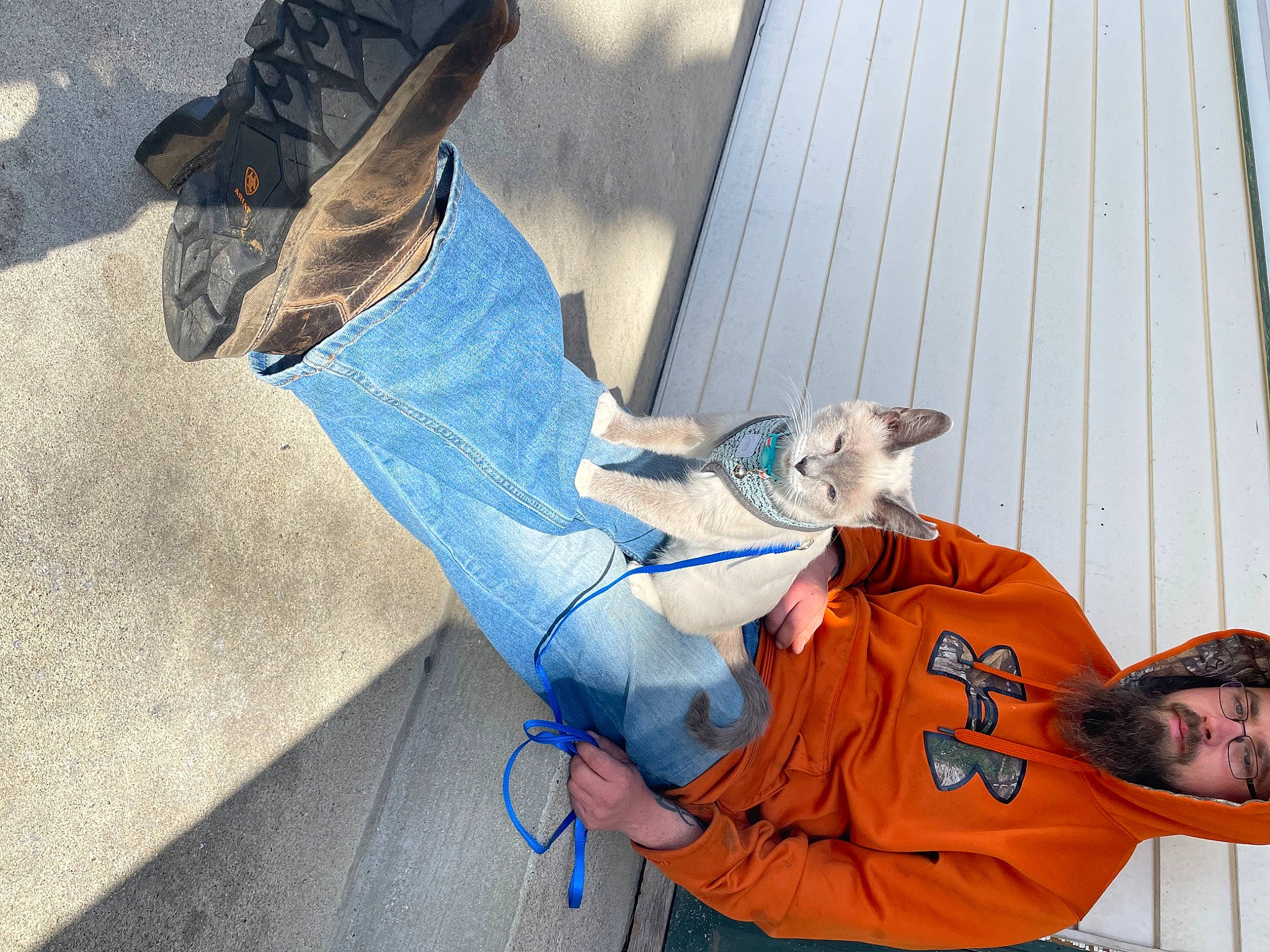 Austin is registered to the contest to win money with this photo: comfort, companion_dog, denim, elbow, electric_blue, flooring, foot, hat, human_leg, knee, leisure, shoe, sitting, sneakers, street_fashion, t_shirt, tail, walking_shoe, wood, wrist