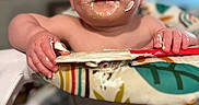 Lilly is registered to the contest to win money with this photo: baby, infant, child, portrait, smiling, messy_face, frosting, cake, food, high_chair, sitting, indoor, close_up, blue_eyes, hands, colorful, celebration, birthday, playful, photography