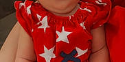 Alexis joined the competition — help win amazing prizes! baby, bow, child, cute, expression, face, freckles, furniture, hand, holding, indoor, infant, legs, newborn, person, portrait, red_clothing, skin, star_pattern, wood