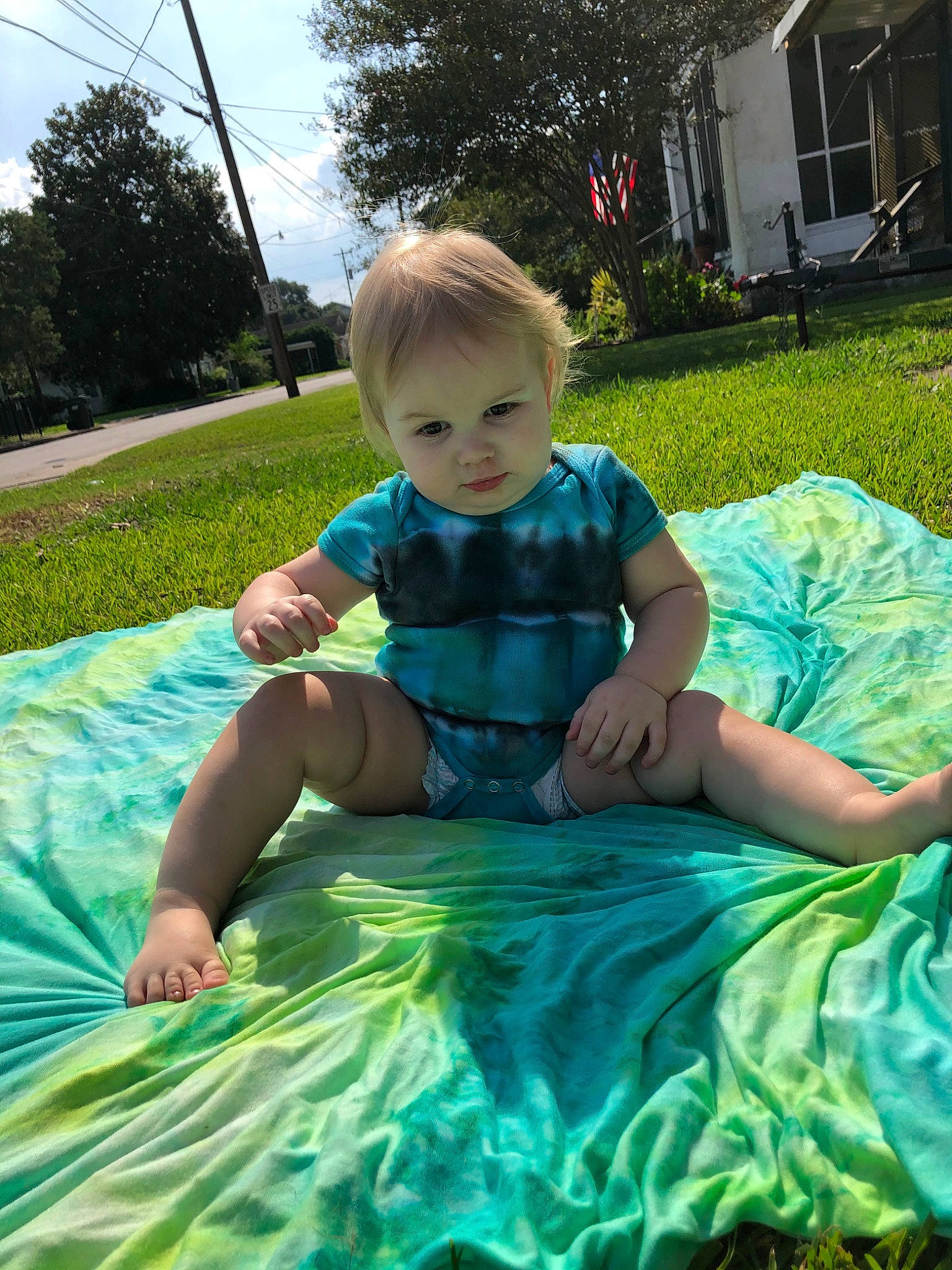 Ivey is registered to the contest to win money with this photo: child, fun, games, grass, green, leisure, person, plant, play, recreation, sitting, smile, summer, toddler, vacation, water