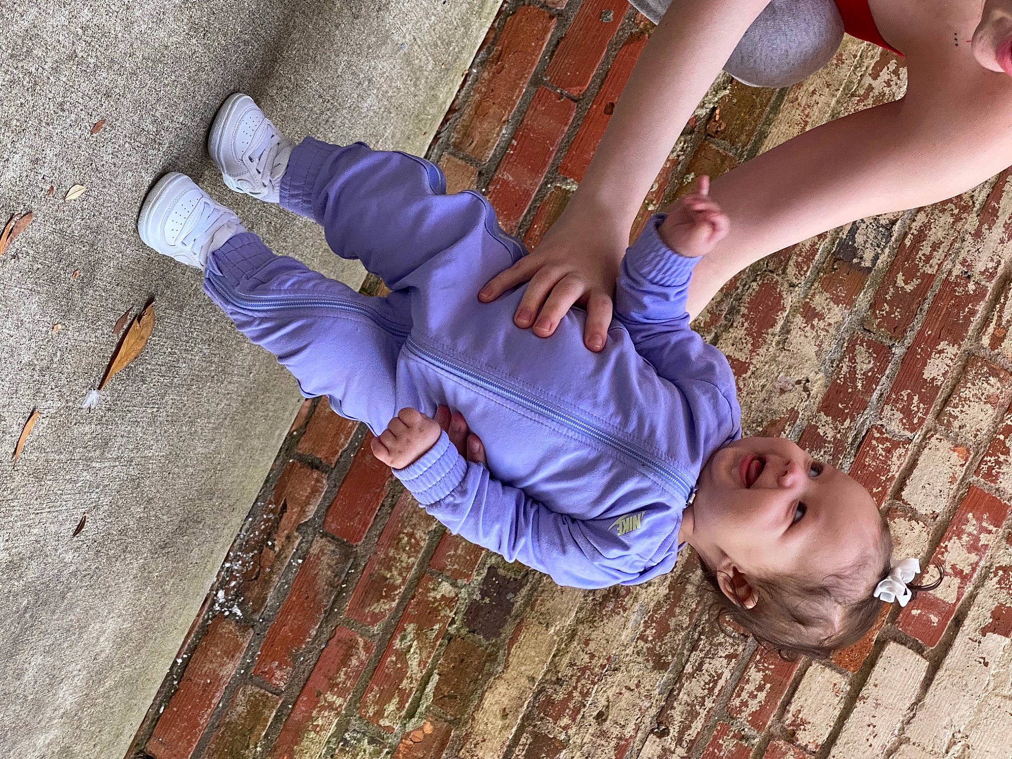 Blakelynn is registered to the contest to win money with this photo: child, electric_blue, face, flooring, flower, foot, fun, gesture, happy, hardwood, human_leg, joint, leg, leisure, person, plant, purple, thigh, thumb, tree