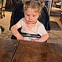 toddler, child, stroller, table, hairstyle, double_buns, outdoor, evening, lights, curious, smile, face, person, clothing, wood, background, restaurant, seat, cute, young