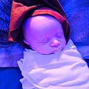 Kolten is registered to the contest to win money with this photo: baby, babywear, blanket, child, closeup, cloth, cute, face, hat, head, indoors, infant, newborn, peaceful, portrait, resting, sleeping, soft, toddler, wrapped