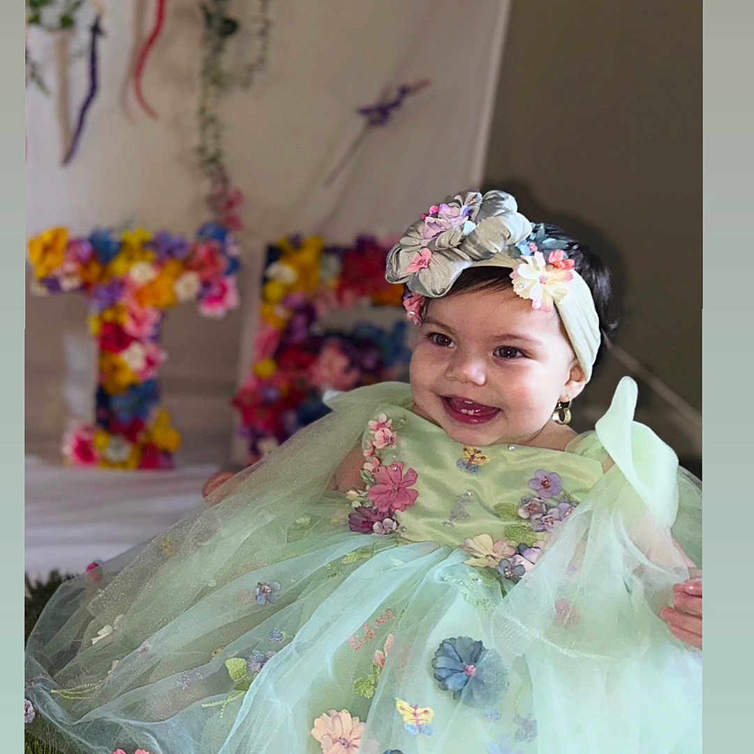 Maite joined the competition — help win amazing prizes! accessories, baby, clothing, costume, dress, face, fashion, flower, flowerarrangement, flowerbouquet, formalwear, gown, happy, hat, head, person, petal, photography, plant, portrait