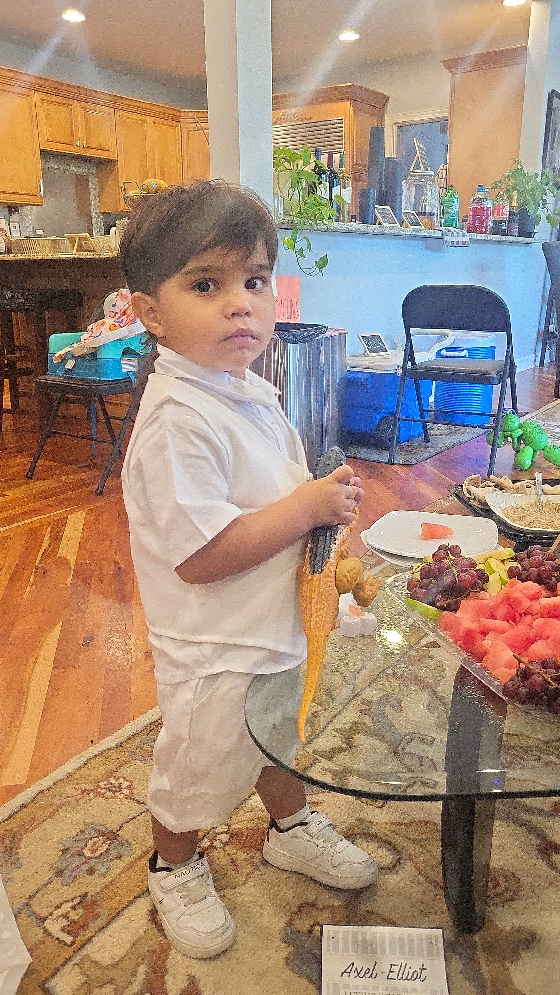 Lionel is registered to the contest to win money with this photo: chair, child, cooking, cuisine, dish, finger_food, flooring, flower, flower_arranging, food, houseplant, ingredient, natural_foods, person, plant, shorts, t_shirt, table, tableware, toddler