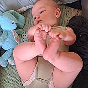 Alec participe au concours pour gagner de l'argent avec cette photo : baby, blue_bunny, child, comfort, couch, cozy, cute, diaper, feet, hands, indoor, infant, knitted_blanket, person, pillow, playing, relaxing, soft, stuffed_toy, toddler