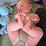 baby, blue_bunny, child, comfort, couch, cozy, cute, diaper, feet, hands, indoor, infant, knitted_blanket, person, pillow, playing, relaxing, soft, stuffed_toy, toddler