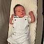River-Bleu is registered to the contest to win money with this photo: baby, infant, crib, clothing, romper, white, pinstripes, buttons, cushion, face, person, newborn, skin, hair, foot, hand, lying_down, indoor, cute, portrait