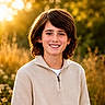 Bryler joined the competition — help win amazing prizes! child, boy, smiling, outdoor, sunset, golden_hour, nature, portrait, happy, casual_clothing, brown_hair, young, field, wildflowers, sunlight, warm_light, person, face, head_and_shoulders, zipper_sweater