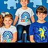 Bryler is registered to the contest to win money with this photo: child, children, smiling, blue_background, puzzle_pieces, bow, tshirt, sitting, standing, happy, portrait, casual_clothing, indoor, group, boy, girl, colorful, fashion, cute, family