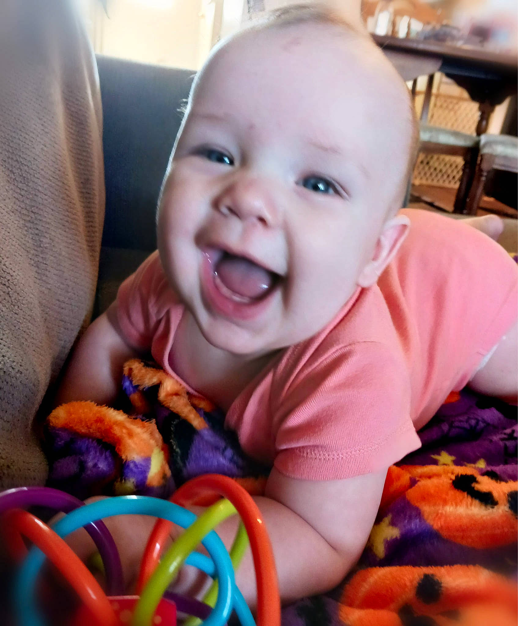 Atlas is registered to the contest to win money with this photo: baby, baby_playing_with_toys, baby_toddler_clothing, cheek, child, finger, happy, iris, lip, mouth, nose, orange, people, person, product, skin, smile, textile, toddler, toy