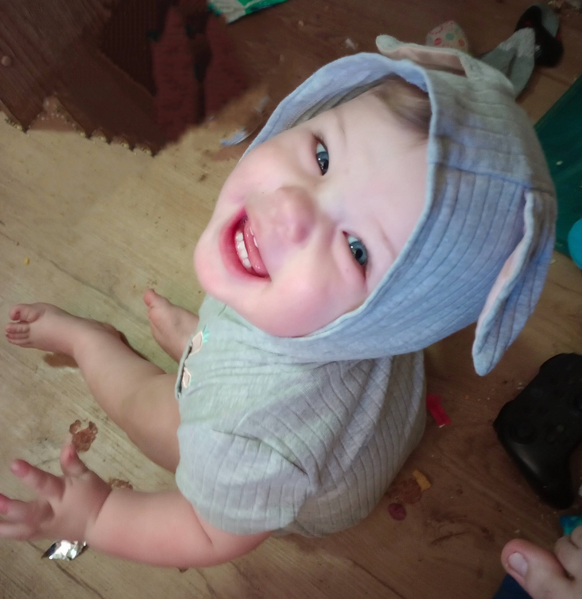 Atlas is registered to the contest to win money with this photo: baby, baby_toddler_clothing, cheek, child, eye, finger, flooring, fun, happy, hardwood, head, headgear, headwear, iris, mouth, nose, person, skin, smile, thumb