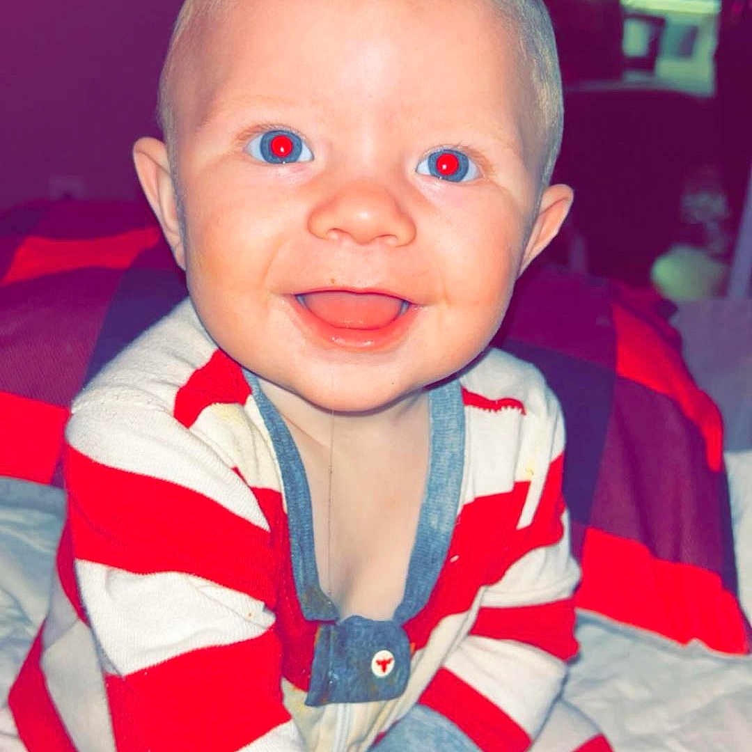 Braxton joined the competition — help win amazing prizes! baby, babylaughing, bed, bedroom, clothing, crawling, cushion, face, furniture, happy, head, indoors, laughing, pants, person, photography, portrait, room, sitting, smile