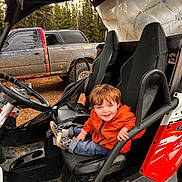 Charlie is registered to the contest to win money with this photo: alloywheel, boy, car, carwheel, child, clothing, face, footwear, head, machine, male, person, photography, portrait, shoe, spoke, tire, transportation, vehicle, wheel