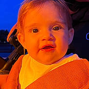 Luísa joined the competition — help win amazing prizes! child, toddler, face, expression, blanket, orange, warm_light, blue_background, curious, close_up, portrait, infant, clothing, baby, seatbelt, stroller, outdoor, evening, skin, eyes