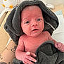 newborn, baby, towel, tattoo, hand, plush_toy, bird_toy, skin, indoor, person, face, eyes, infant, soft_texture, cute, baby_hand, blanket, expression, portrait, resting