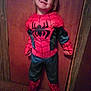 barefoot, black, casual, child, clothing, costume, floor, full_body, fun, happy, indoor, person, portrait, red, smile, spiderman, standing, wall, wooden_door, young_child