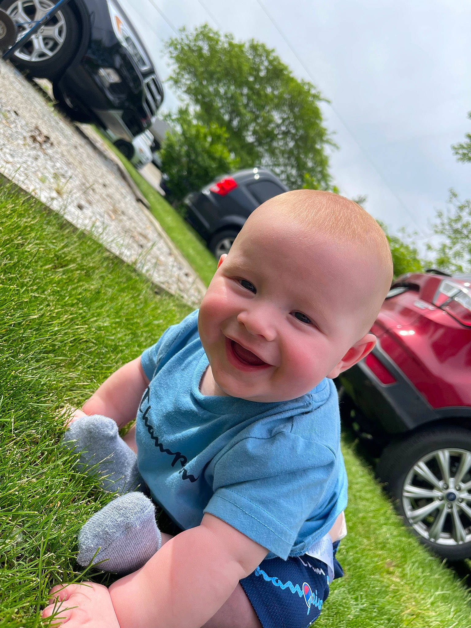 Greysen joined the competition — help win amazing prizes! arm, automotive_design, automotive_exterior, automotive_tire, baby, car, grass, hand, happy, joy, leisure, person, plant, recreation, sky, smile, summer, tire, toddler, tree