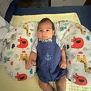 Thiago Cespedes joined the competition — help win amazing prizes! baby, infant, child, portrait, lying_down, indoors, changing_pad, overalls, striped_shirt, striped_socks, anchor, animal_print, giraffe, elephant, lion, colorful, bed, nursery, furniture, face