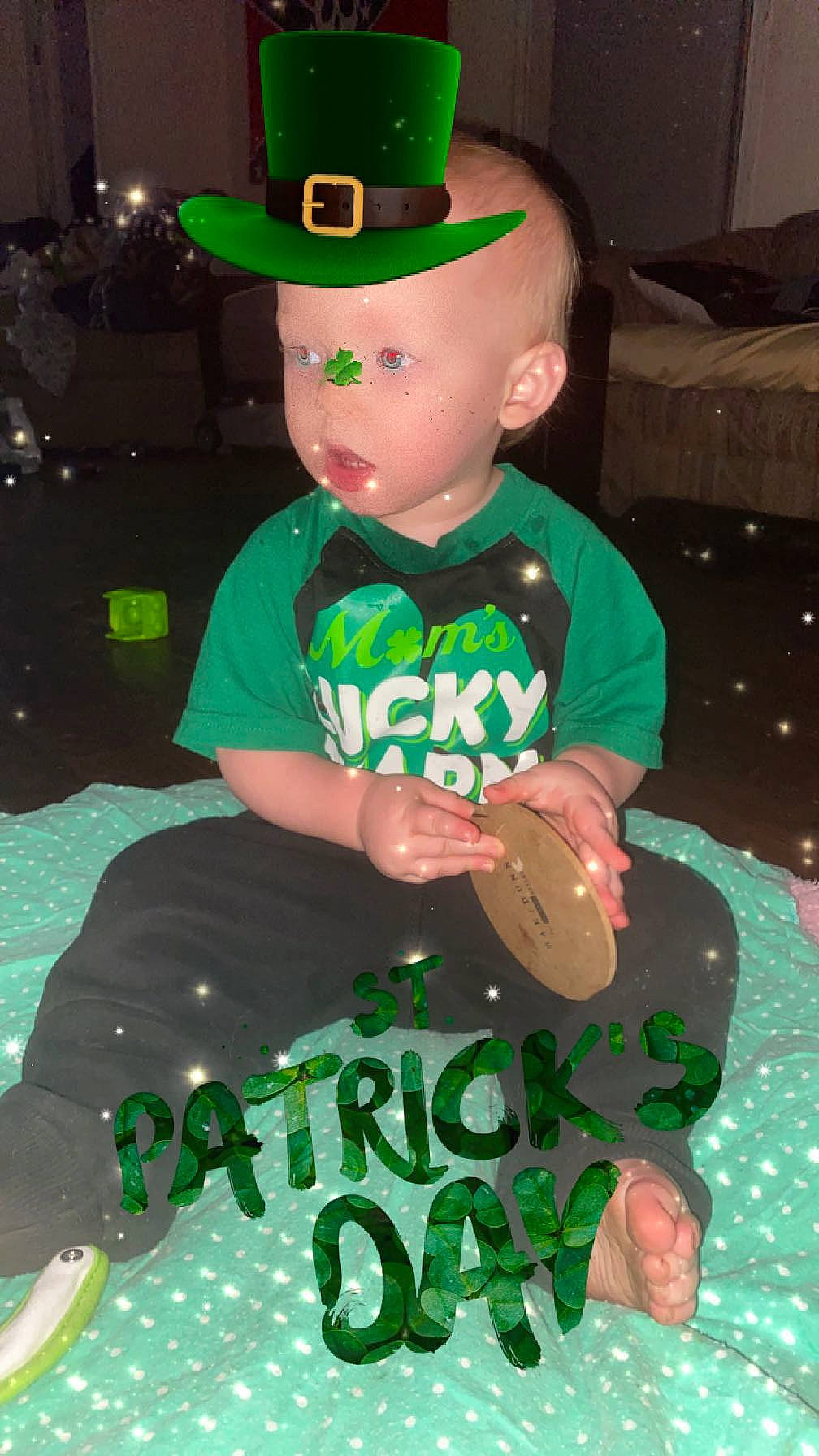 Gavin is registered to the contest to win money with this photo: baby_toddler_clothing, balloon, baseball_cap, cap, child, costume_hat, event, fashion_accessory, fictional_character, fun, green, happy, hat, holiday, party, party_supply, pattern, person, sleeve, t_shirt