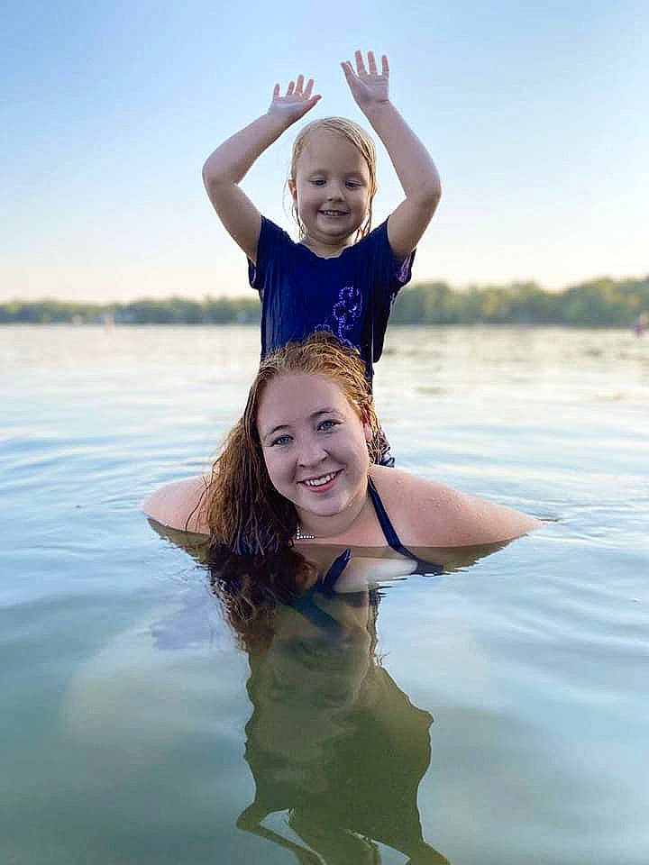 Addison is registered to the contest to win money with this photo: bank, barefoot, blond, event, flash_photography, fun, gesture, happy, human_body, joy, lake, leisure, long_hair, ocean, people_in_nature, people_on_beach, person, recreation, shoulder, sky