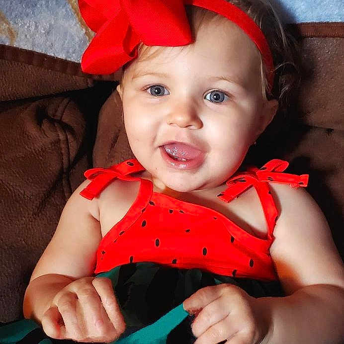 Amelia joined the competition — help win amazing prizes! accessories, baby, babylaughing, bodypart, clothing, costume, couch, dress, face, formalwear, furniture, happy, head, mouth, person, photography, portrait, smile, teeth, tie