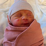 Isla is registered to the contest to win money with this photo: newborn, baby, infant, swaddle, hat, sleeping, portrait, close_up, face, cheeks, blanket, hospital, pink, skin, cute, peaceful, headwear, maternity, wrapped, newborn_cap