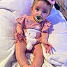 baby, infant, child, pacifier, pink_outfit, headband, bunny_design, blanket, sitting, cute, soft_texture, indoors, portrait, young_child, clothing, footwear, hand, face, eyes, expression