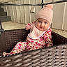 baby, child, infant, basket, hat, knit_hat, pom_pom, onesie, floral_pattern, pink, smile, face, curious, indoor, stairs, wall, seated, cute, cozy, portrait