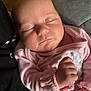 baby, child, closeup, cozy, cuteness, face, fist, hand, indoor, infant, newborn, peaceful, person, pink_clothing, portrait, rest, skin, sleeping, soft_light, young