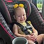baby, child, car_seat, graco, smile, yellow, flower, hair_accessories, seatbelt, window, car_interior, safety, infant, cute, happy, portrait, seat, clothing, hands, road_trip