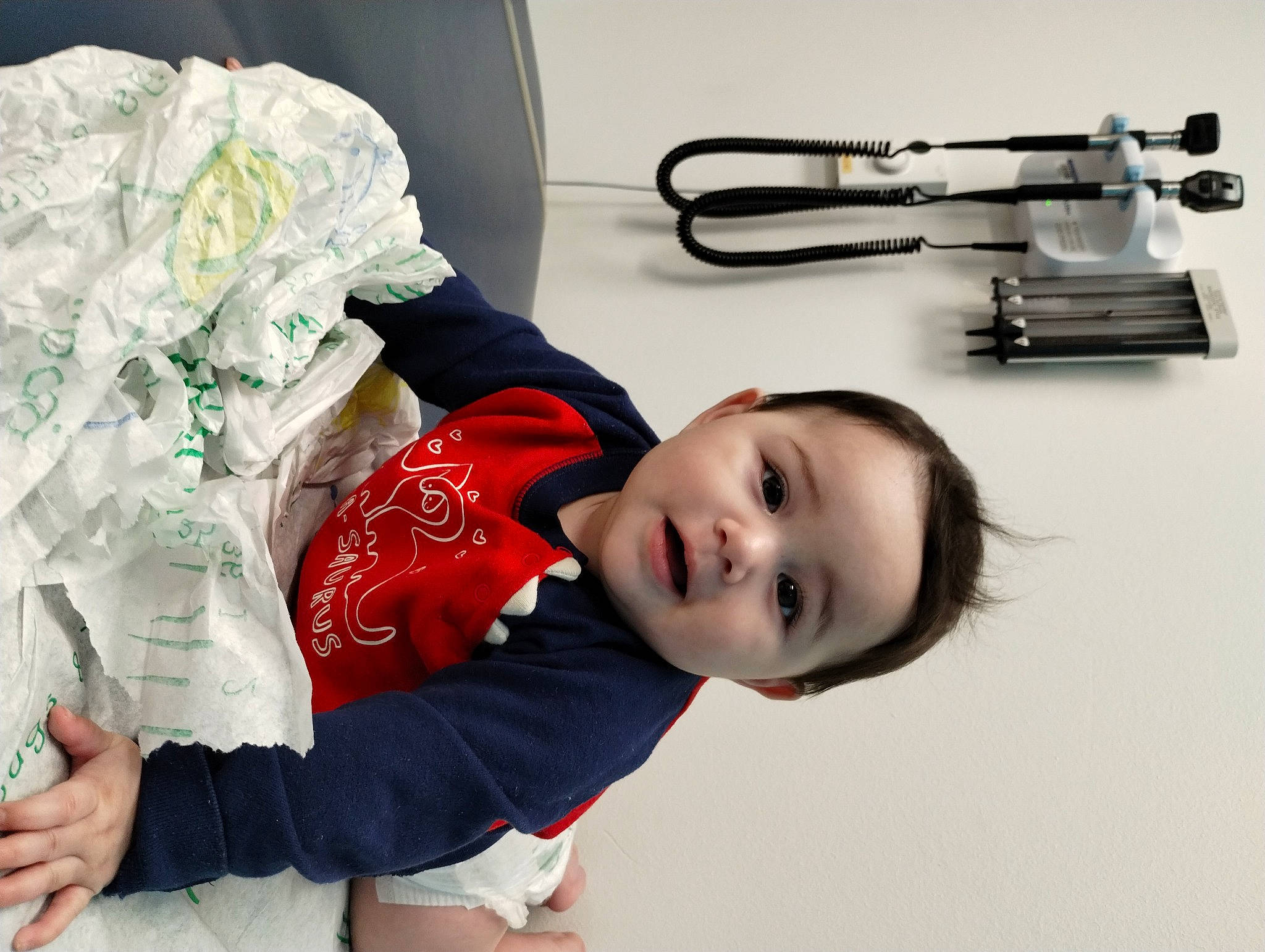 Sakura is registered to the contest to win money with this photo: automotive_exhaust, baby, baby_toddler_clothing, carmine, child, comfort, fashion_accessory, fun, happy, metal, person, sitting, sleeve, t_shirt, toddler, white, wind_instrument