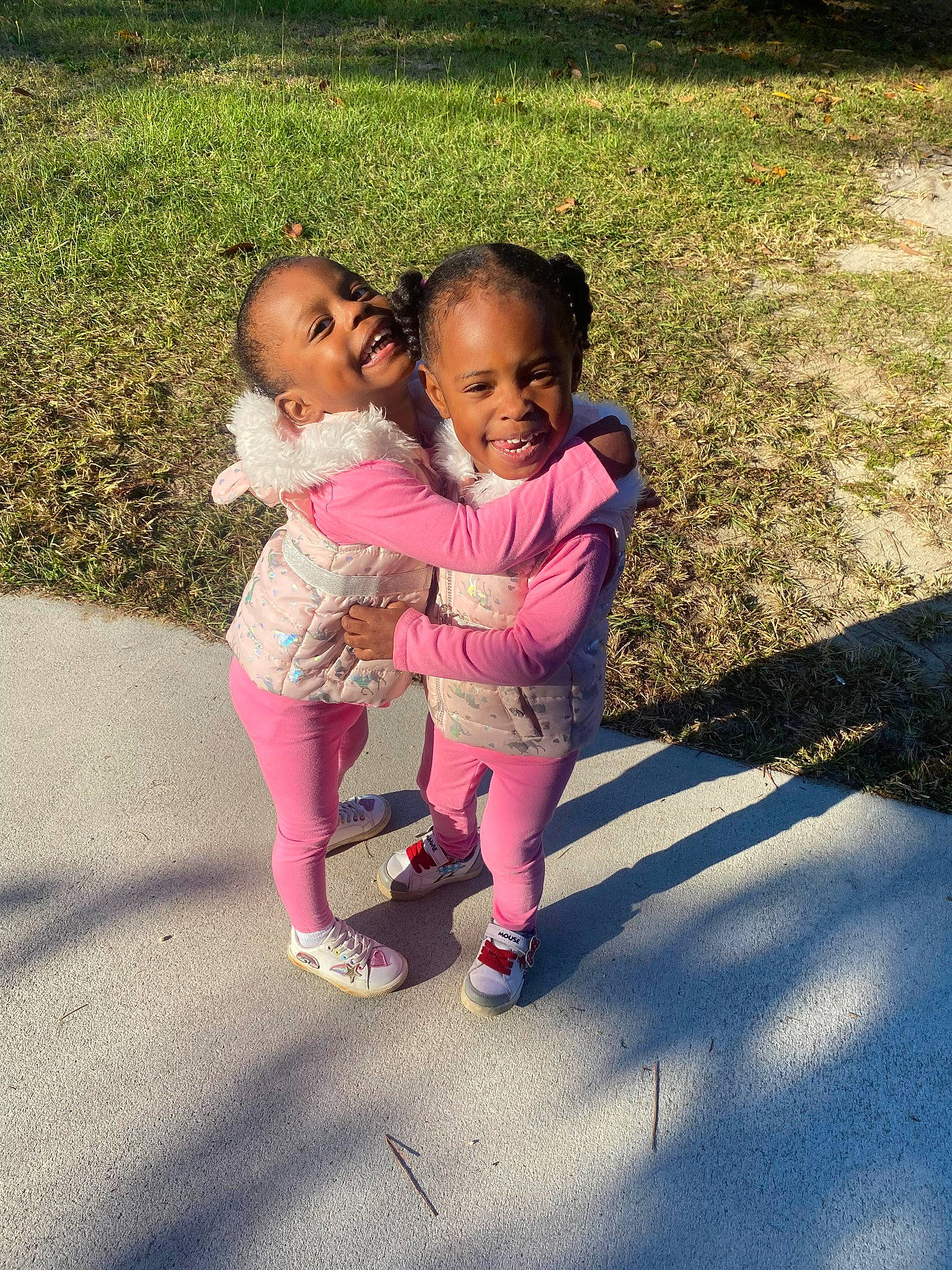 Brooklynn is registered to the contest to win money with this photo: asphalt, baby, baby_toddler_clothing, face, fun, gesture, grass, hand, happy, head, human_body, joy, leg, leisure, magenta, people_in_nature, person, pink, plant, recreation