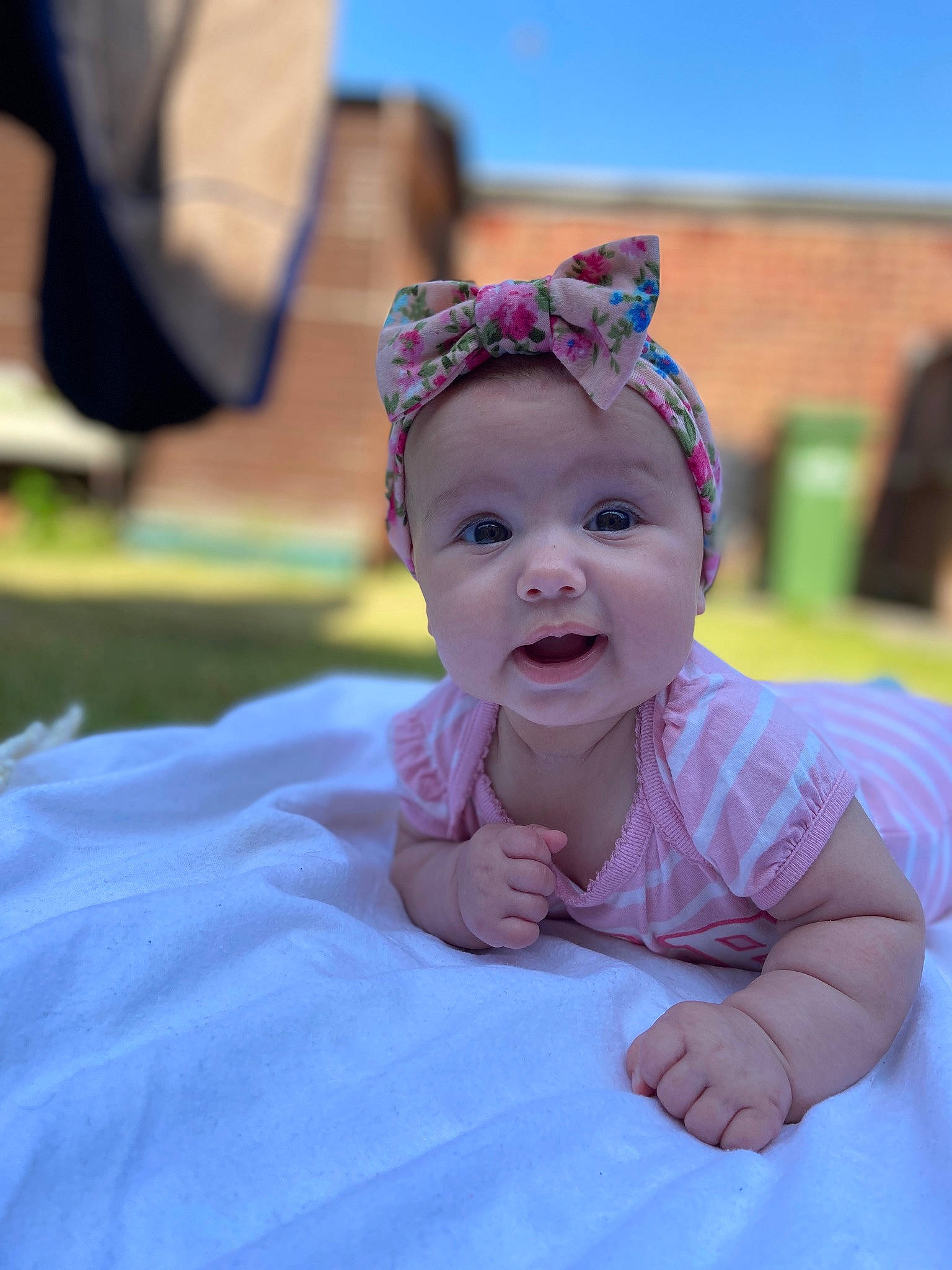 Emma joined the competition — help win amazing prizes! baby, baby_toddler_clothing, child, event, fashion_accessory, fun, grass, hair_accessory, happy, hat, headgear, headpiece, headwear, laugh, leisure, person, recreation, sitting, sky, smile