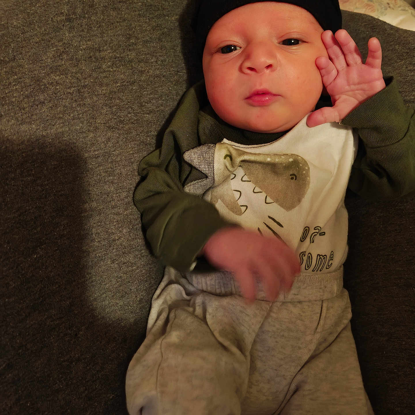 Ryatt joined the competition — help win amazing prizes! baby, bed, blanket, cheek, cozy, cushion, expression, eyes_open, face, hand, hat, indoor, infant, lying_down, mouth, newborn, onesie, pajamas, portrait, skin